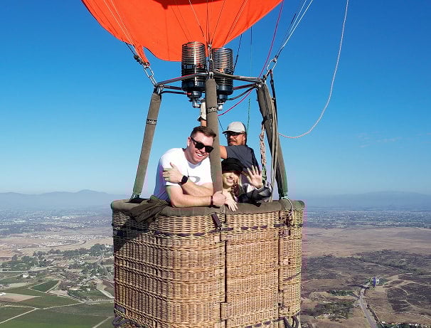 Three people in a hot air balloon